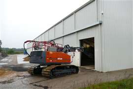 The excavator being driven into the hall structure covering the Dethlinger Pond