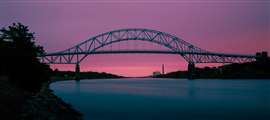 The sun sets on the Sagamore Bridge. (Image: Adobe Stock)