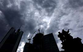Dark clouds are seen over the construction site of "4 Frankfurt" skyscraper next to the statue of German inventor Johannes Gutenberg and the Commerzbank tower in Frankfurt, Germany, July 19, 2023. REUTERS/Kai Pfaffenbach/File Photo