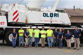 The Olori team lined up in front of an Olori crane