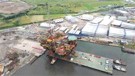 Aerial view of Brent Charlie topsides on Iron Lady barge making final approach to quayside in Hartlepool, UK