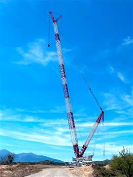 side view of fully assembled Liebherr LR 1700-1.0W narrow track heavy lift crawler crane in the red and white livery of Gruas Aguado