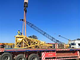 Unloading one of the larger crawler crane components for shipping