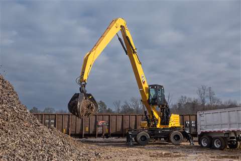 Cat MH3050 material handler lifting scrap metal