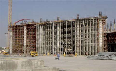 Self-made chute for concreting works. Concrete pours down a wooden