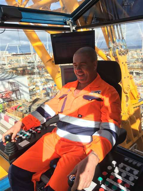 This crane operator is smiling for a reason: he gets to operate the ‘world’s largest crane’