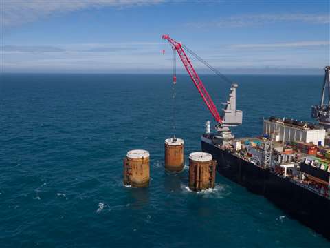 A service crane on the Pioneering Spirit lifted the leg covers and placed them on the three legs